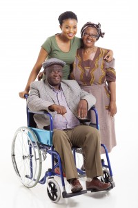 handicapped african man with wife and daughter